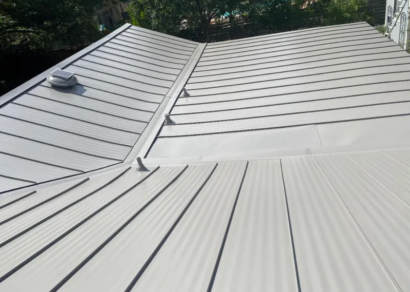 Solar attic fan installed on a metal roof for Roof Ventilation in Imperial